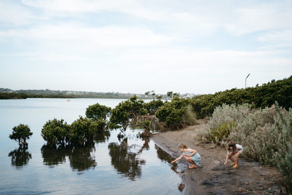 a natural image of two girls playing near the water in a town in Australia