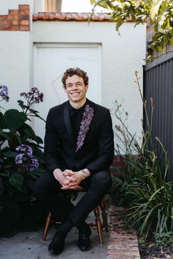Ben Brown AFL football player seated portrait in a jacket custom designed for the Brownlow