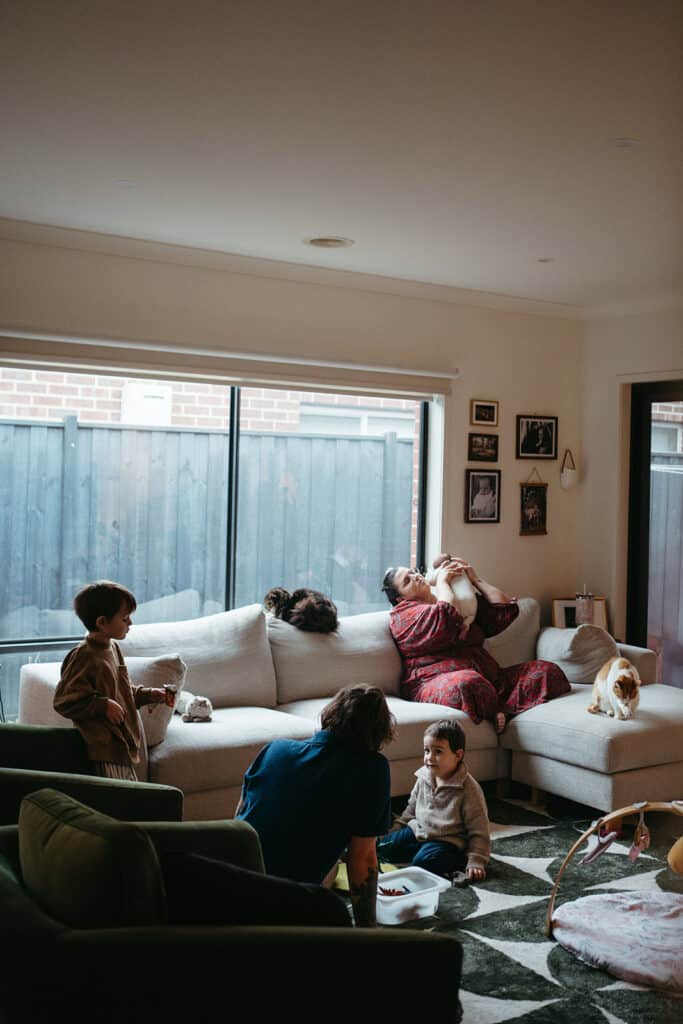 family sit in living room at home together