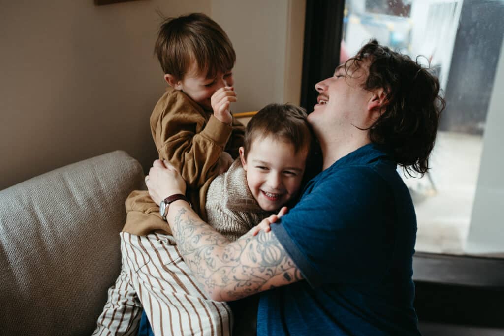 father plays with his two young boys