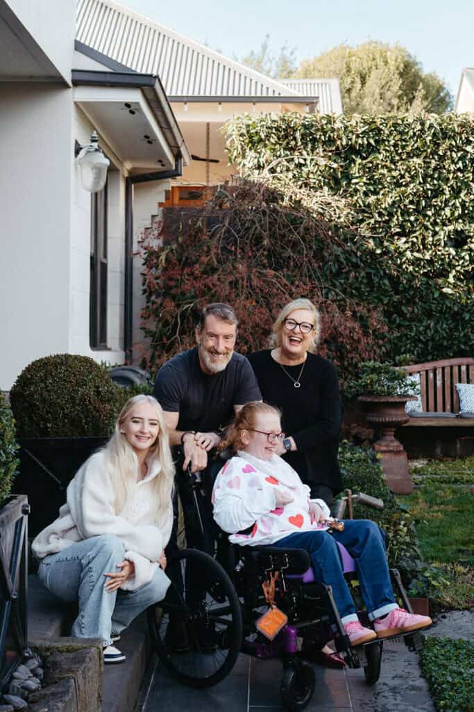 Family of four one child with a disability in wheelchair 