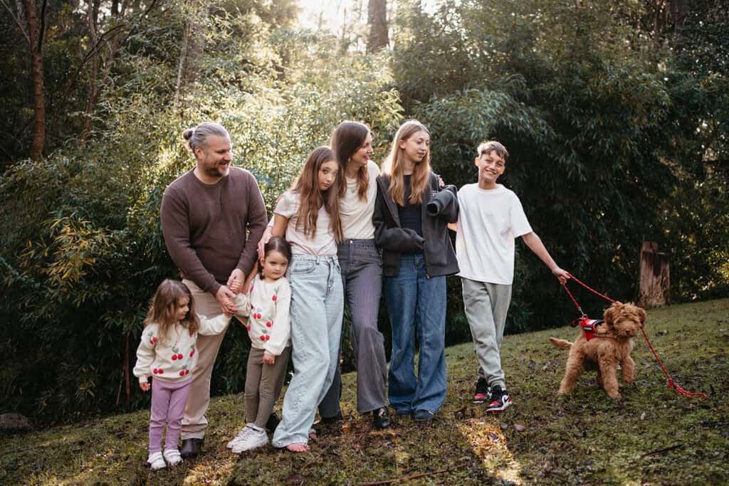 a family looking natural and real during a family photography session with their dog outside