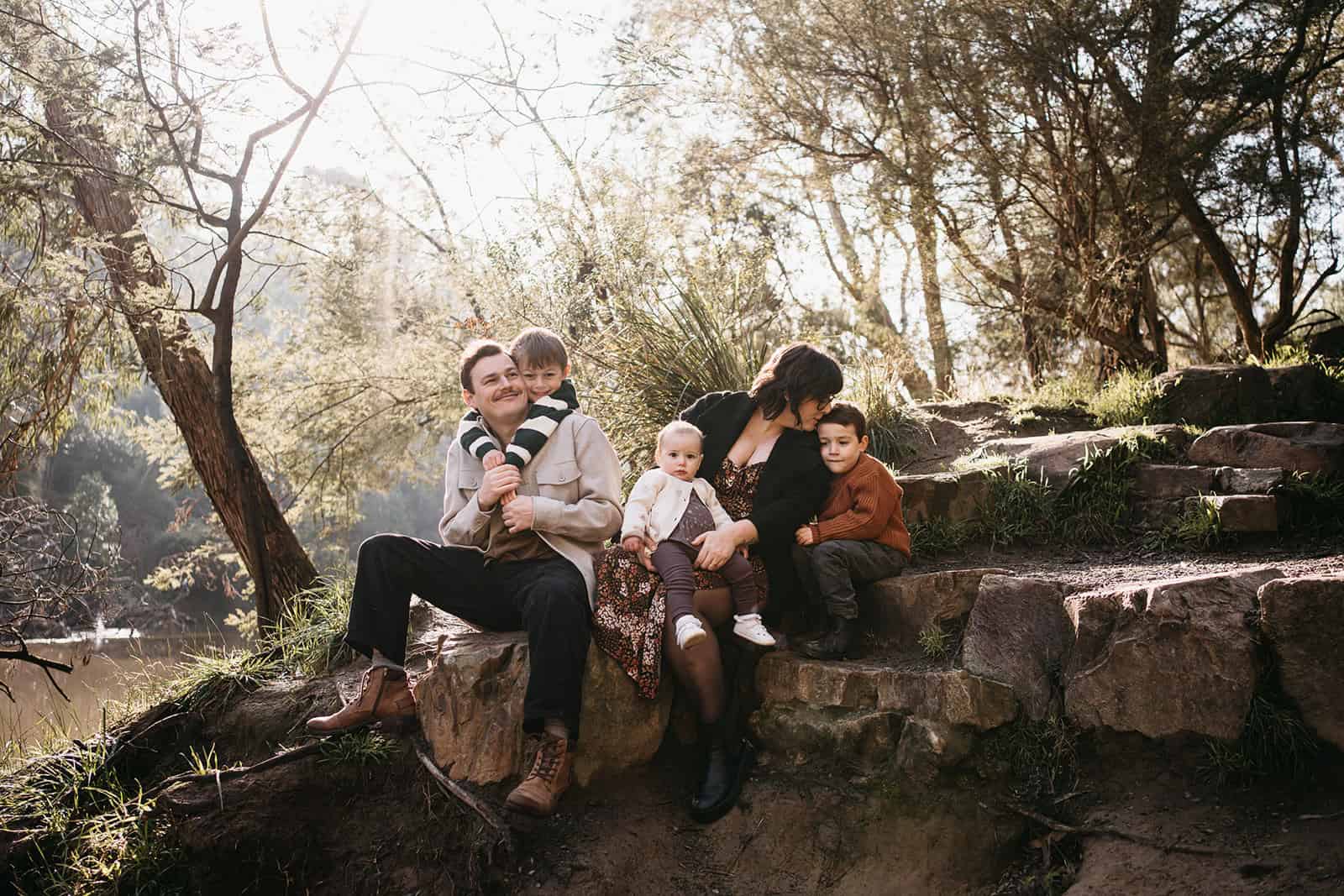 a family photoshoot on rocks near warrandyte river
