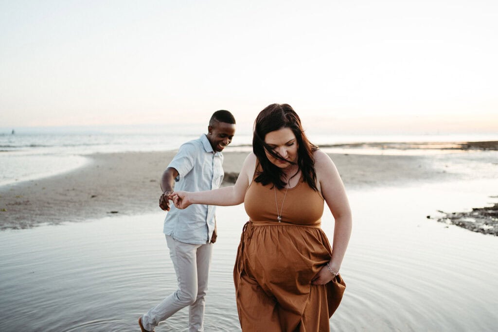 a couple walk towards the camera maternity session in Melbourne