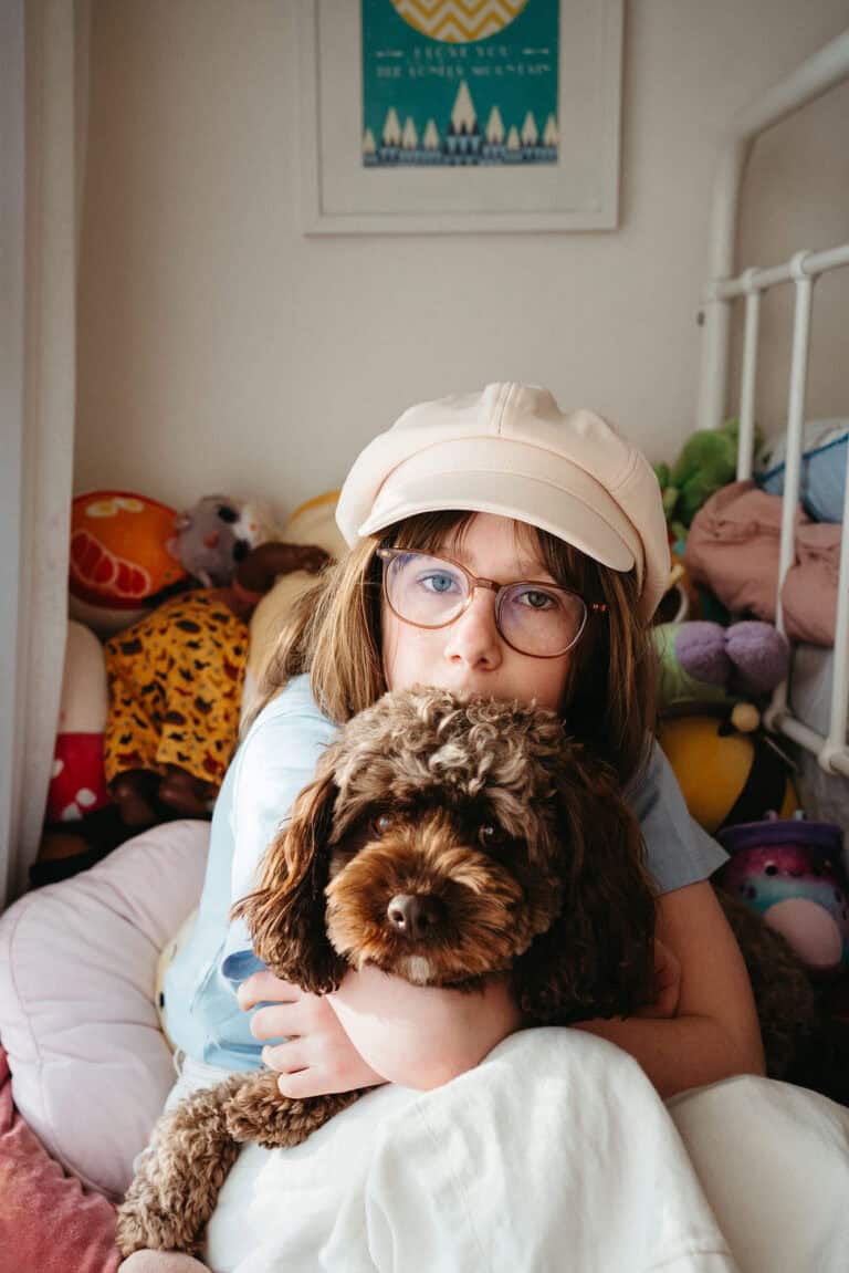 Melbourne family photographer’s daughter with cavoodle in colourful room