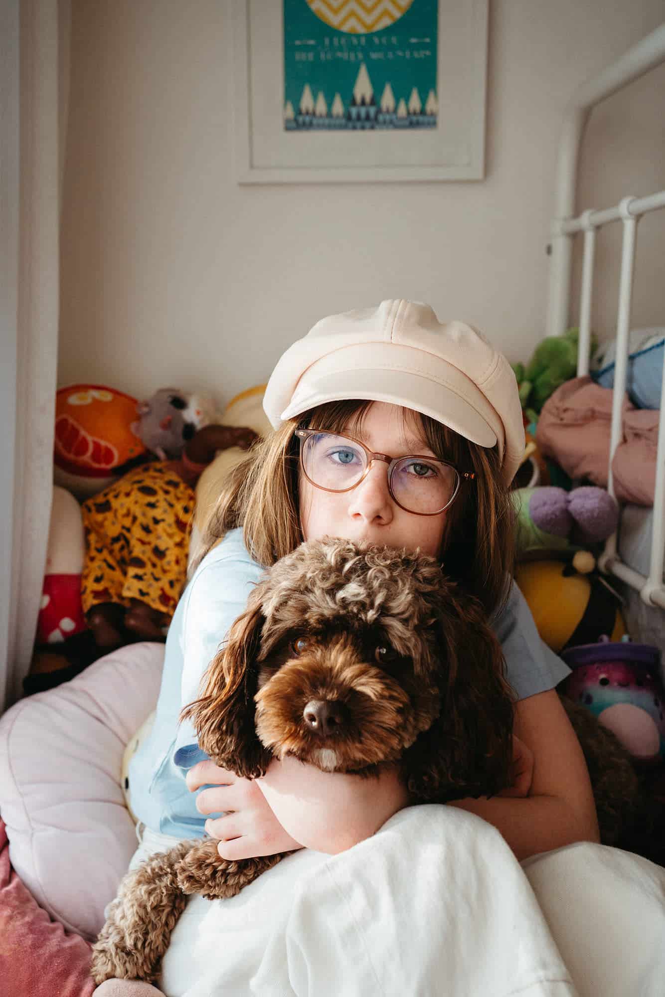 Melbourne family photographer’s daughter with cavoodle in colourful room