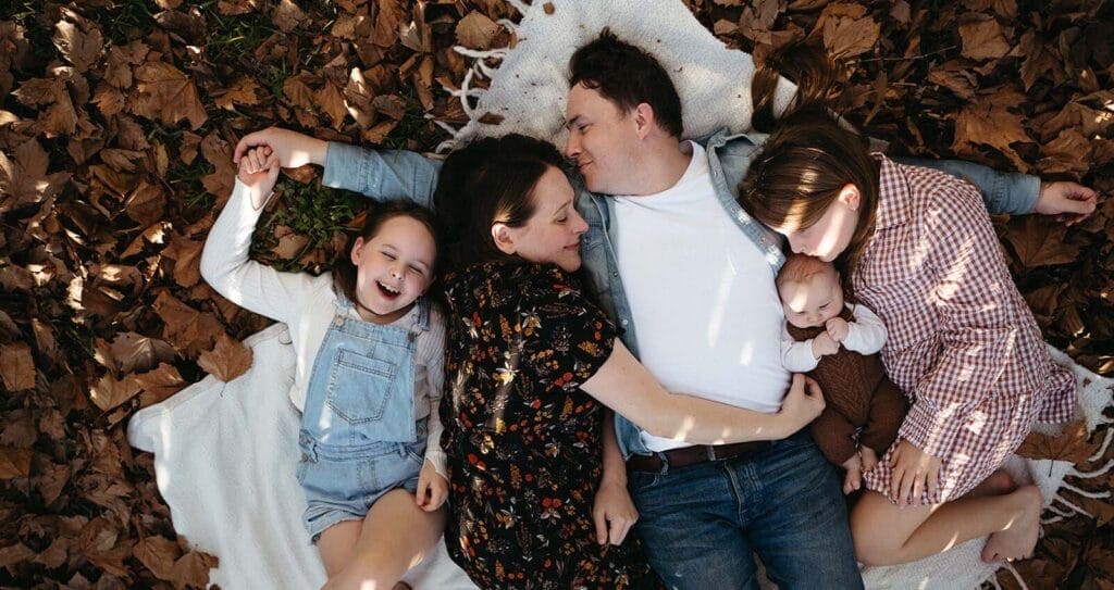 a top down view of a family lying on a picnic blanket during a family photography session in melbourne