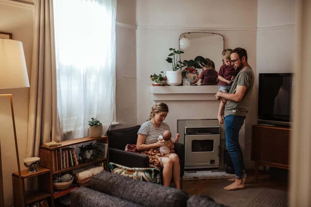 Melbourne family wearing coordinated soft earthy tones during relaxed newborn photography session