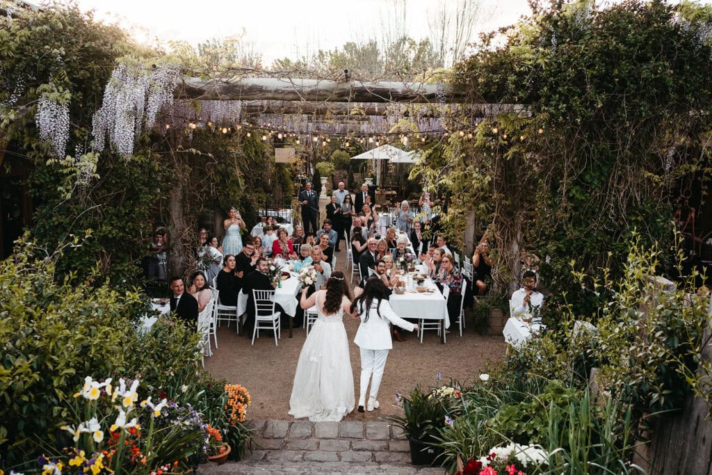 two brides make their entrance to their wedding reception at alowyn gardens in the yarra valley