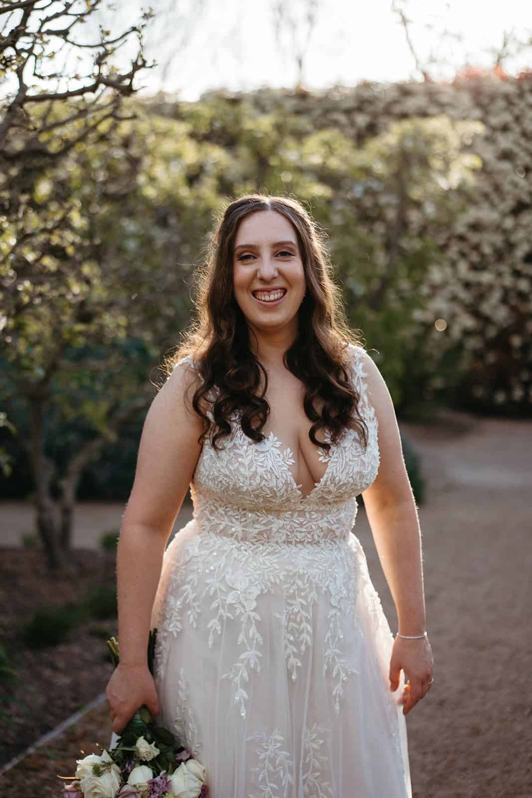 bride at Alowyn Gardens in a Justin Alexander dress