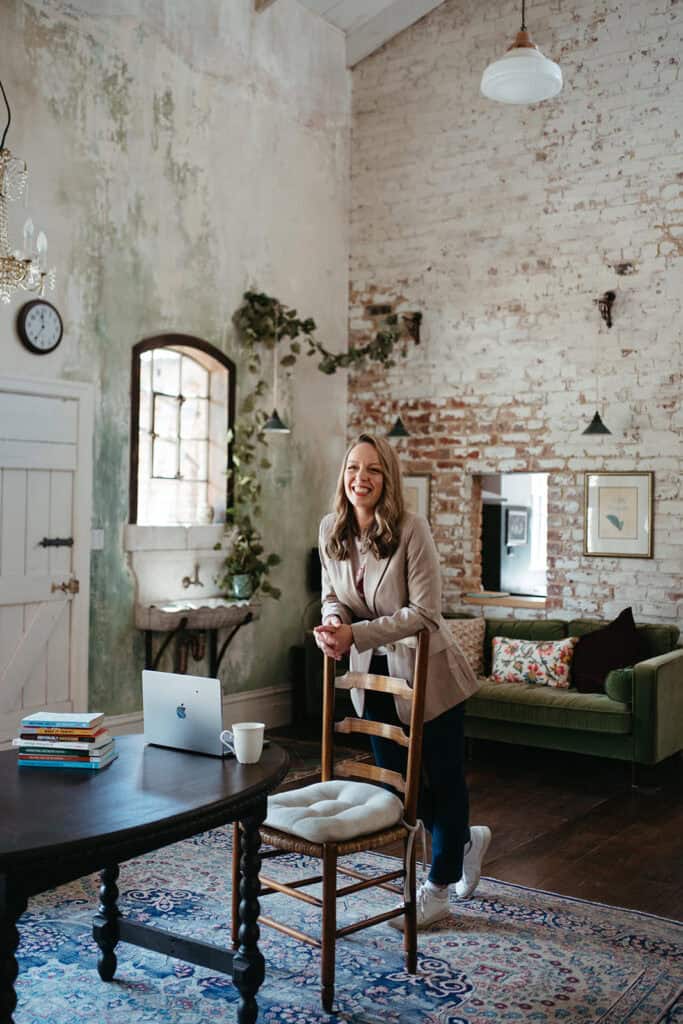 casual portrait of a business woman and gardening podcaster in melbourne leaning agains the back of a chair