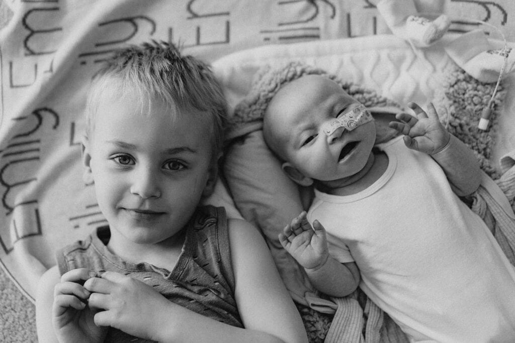 in-home newborn photography Melbourne siblings older child and baby