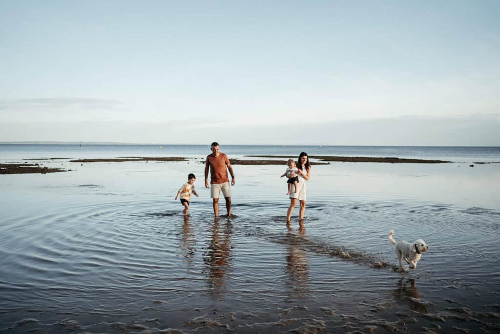 family in the water at beaumaris lifesaving club beach near ricketts point