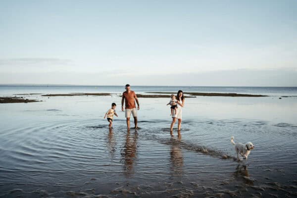 family in the water at beaumaris lifesaving club beach near ricketts point