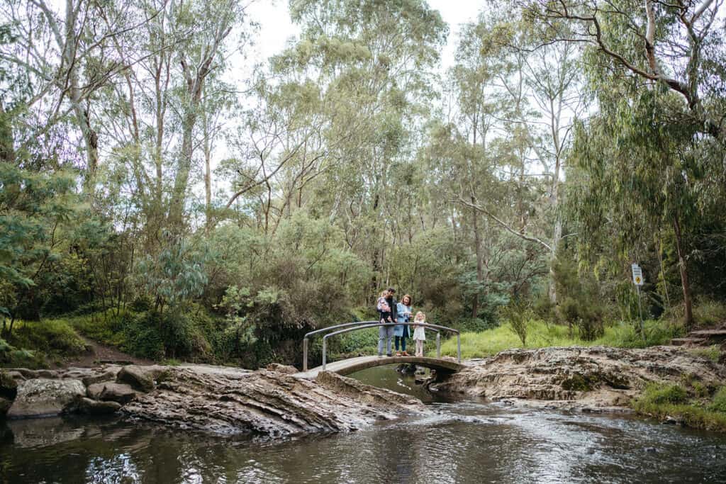 a family stands on a bridge in darebin parklands